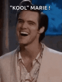 a man in a suit is laughing with the words `` kool '' marie written above him .