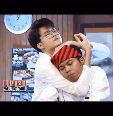 two men are hugging each other in front of a special promotion sign