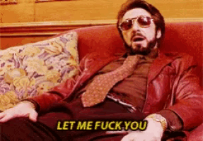 a man in a red jacket and tie is sitting on a couch with the words let me fuck you above him