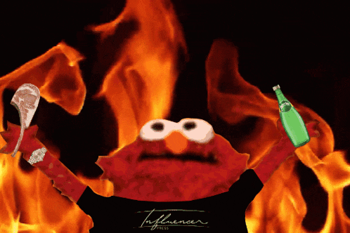 elmo is holding a bottle of perrier in front of a fire