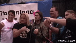 a group of men standing in front of a sign that says tito santana