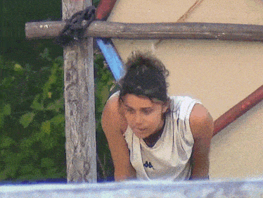 a woman wearing a kappa shirt looks down