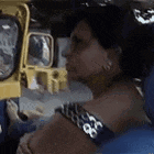 a woman is sitting in the back seat of a car .