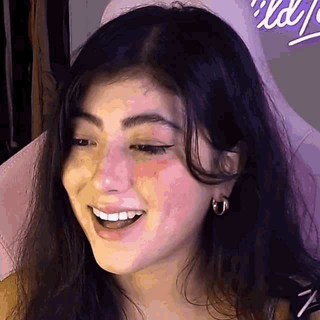 a close up of a woman 's face with a pink background .
