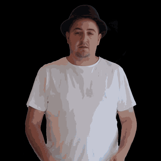 a man wearing a white t-shirt and a black hat