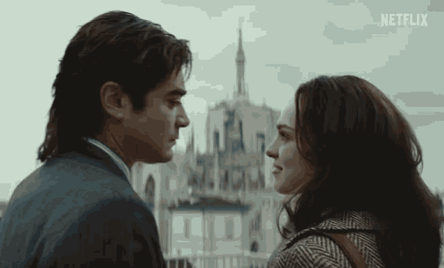 a man and woman are looking into each other 's eyes with a netflix logo in the background
