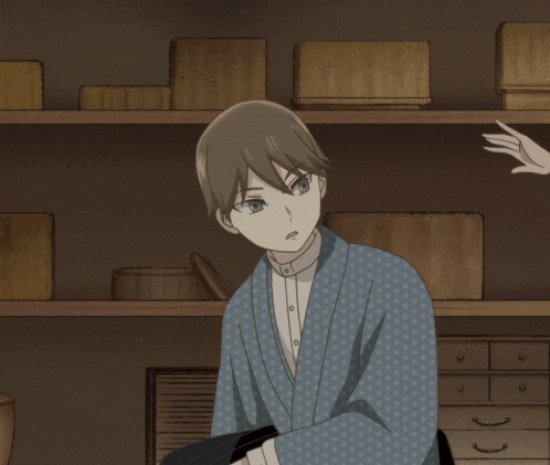 a woman in a green kimono talks to a boy