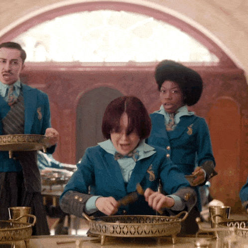 a group of people in blue uniforms are standing around a table with a tray that says 1000 on it