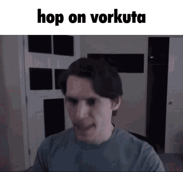 a man in a blue shirt is making a funny face with the words hop on vorkuta below him