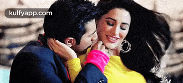 a man is kissing a woman on the neck in a movie scene .