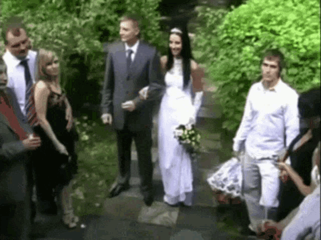 a bride and groom are walking down the aisle with their wedding guests