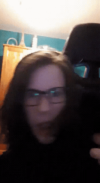 a person wearing glasses and a black shirt