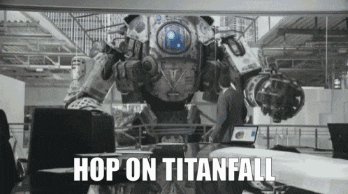 a man is sitting in front of a robot that says hop on titanfall .
