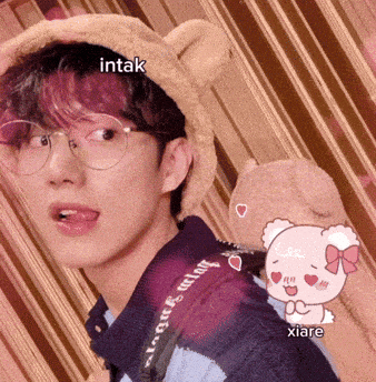a young man wearing glasses and a teddy bear hat with the words intak and xiare below him