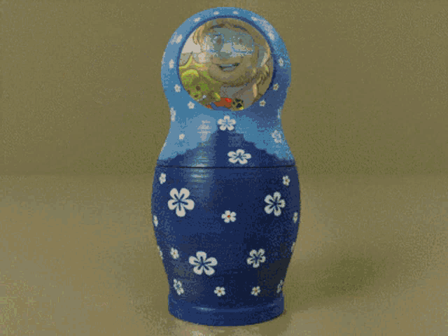 three russian nesting dolls with a green one with glasses