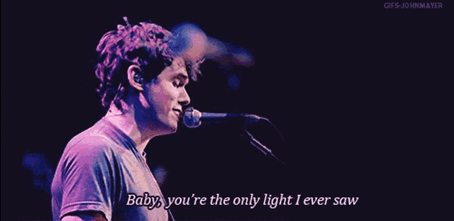 a man singing into a microphone with the words baby you 're the only light i ever saw below him