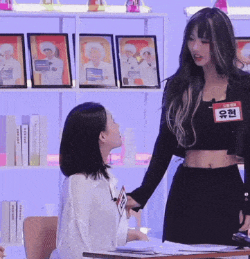 a girl with a name tag that says exit is standing next to another girl