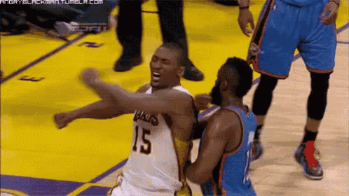 a basketball player with the number 15 on his jersey is being punched by another player