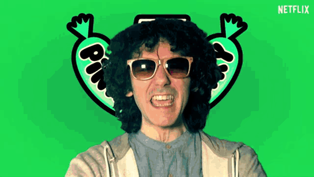 a man wearing sunglasses is giving a thumbs up sign