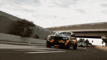a black and yellow jeep is driving on a highway