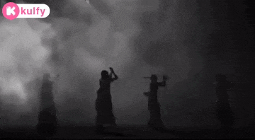 a black and white photo of a group of people dancing with a kulfy logo in the background