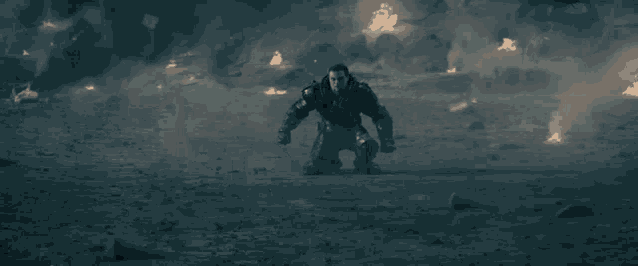 a blurry picture of a man running through a smokey area with a fire in the background .