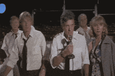 a group of people are standing around a man with a microphone in his hand