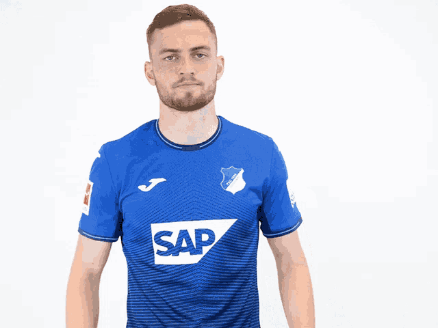 a man wearing a blue shirt with the word sap on the front