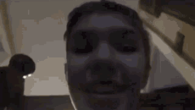 a close up of a person 's face in the dark .