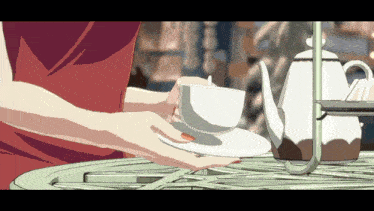a woman in a red dress is holding a white cup on a saucer