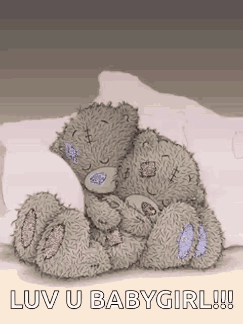 a teddy bear laying on a bed with the words " luv u babygirl " on the bottom