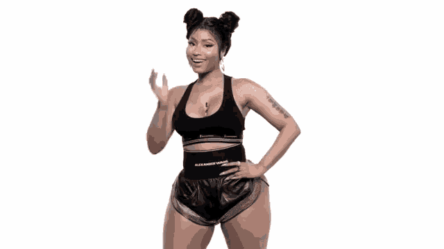 a woman wearing a black tank top and shorts with the word alexander on the waistband