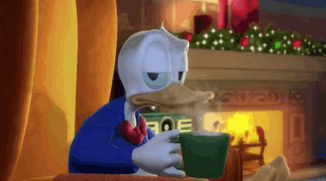 donald duck is drinking a cup of hot chocolate in front of a fireplace .