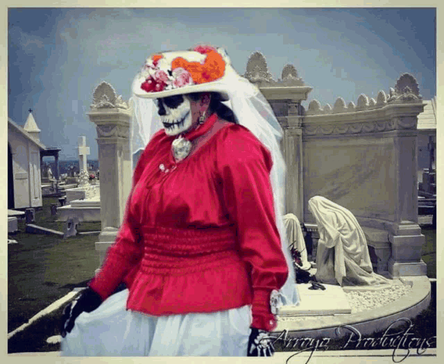 a woman in a red top and white skirt is standing in a cemetery with the words array productions written on the bottom