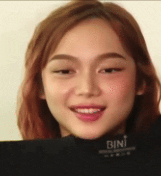 a close up of a woman 's face with the word bini visible
