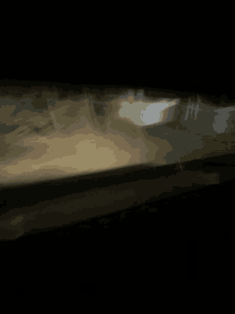 a blurry picture of a car driving down a road