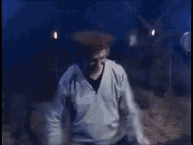 a blurry picture of a man wearing a mask and a red hat