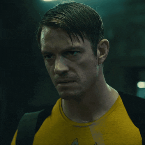 a man wearing a yellow shirt with a star trek logo