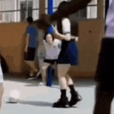 a group of people are standing in a gym .