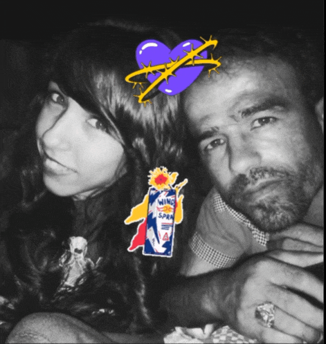 a black and white photo of a man and a girl with a sticker on the girl 's head that says wing spray