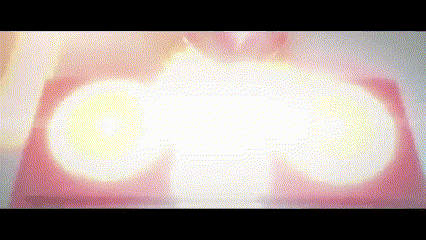 a blurred image of a person 's face with a few lights coming out of it .