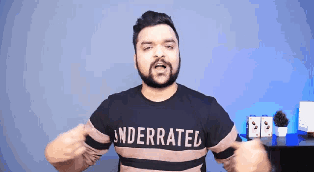 a man wearing a shirt that says underrated on it