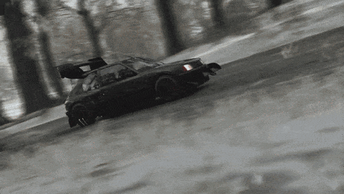 a car is driving down a snow covered road