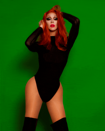 a woman with red hair wearing a black bodysuit and thigh high boots