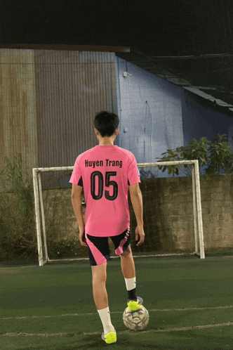 a soccer player wearing a pink shirt with the number 05