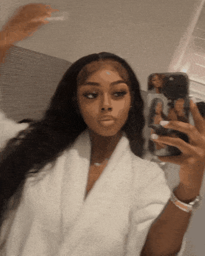 a woman is taking a selfie with her phone