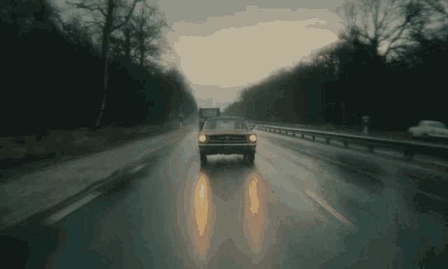 a ford mustang is driving down a highway