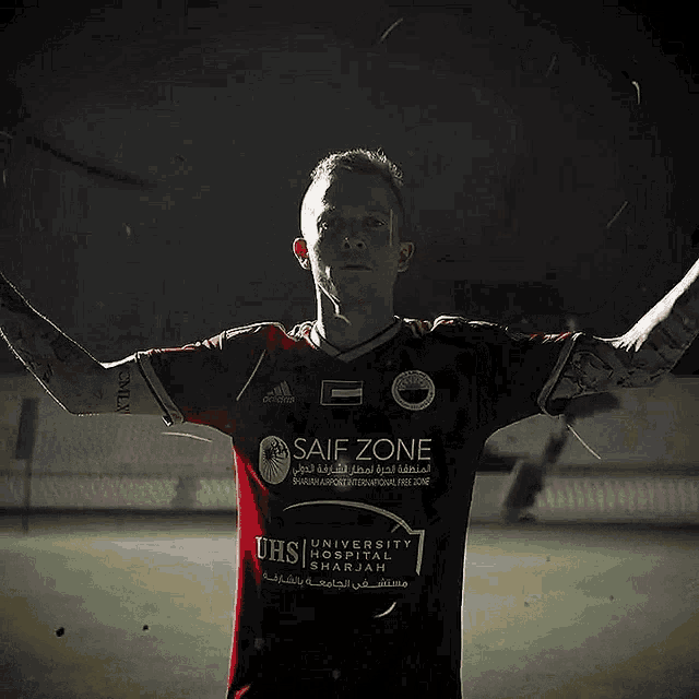 a soccer player wearing a red shirt that says safe zone