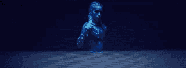a woman 's face is projected on a screen in a dark room