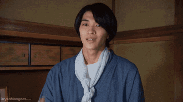 a man in a blue kimono looks up at the sky